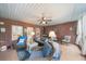 Charming screened-in porch with brick walls, tile floors, comfortable seating, and tranquil outdoor views at 1410 Daley Ridge Ct, Lawrenceville, GA 30045