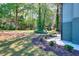 Spacious backyard with manicured landscaping, mature trees, and pathway at 2538 Three Bars Drive, Grayson, GA 30017