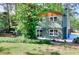 Landscaped backyard featuring a well-maintained lawn and mature trees, enhancing privacy at 2538 Three Bars Drive, Grayson, GA 30017