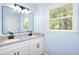 Bathroom with double vanity, granite countertop, black hardware, modern mirror and a bright window at 2538 Three Bars Drive, Grayson, GA 30017