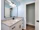 Bathroom with white vanity, granite counters, black hardware, and framed mirror at 2538 Three Bars Drive, Grayson, GA 30017