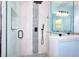 Modern glass shower with black hardware and a shower head; a tiled accent wall adds texture and design at 2538 Three Bars Drive, Grayson, GA 30017