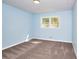 Light blue bedroom featuring carpet, a window, and a ceiling light at 2538 Three Bars Drive, Grayson, GA 30017