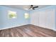 Bright bedroom with light blue walls, wood floors, ceiling fan, and a large closet with stylish barn doors at 2538 Three Bars Drive, Grayson, GA 30017