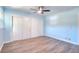 Light blue bedroom with wood floors, ceiling fan, and large closet with white barn doors at 2538 Three Bars Drive, Grayson, GA 30017