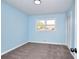 Light blue bedroom with carpet, a window, and a closet at 2538 Three Bars Drive, Grayson, GA 30017