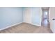 This bedroom offers neutral carpet, blue walls, and closet with white, louvered doors at 2538 Three Bars Drive, Grayson, GA 30017
