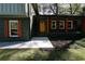 Exterior view of a home with a brick facade, colorful accents, and a covered porch at 2538 Three Bars Drive, Grayson, GA 30017