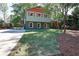 View of a two-story home with colorful exterior and a green lawn at 2538 Three Bars Drive, Grayson, GA 30017