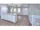 Living room view showcases a kitchen island, hardwood flooring, and front door at 2538 Three Bars Drive, Grayson, GA 30017