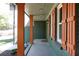 Covered porch with brick columns and vibrant, colorful trim and accents at 2538 Three Bars Drive, Grayson, GA 30017