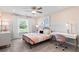 Charming bedroom with soft pink accents, a comfy bed, bright window, and a functional desk space for relaxation at 328 Foxglove Way, Mcdonough, GA 30253