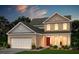 Charming two-story home boasts manicured landscaping, a two-car garage, and a classic brick facade at 328 Foxglove Way, Mcdonough, GA 30253