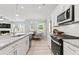 Kitchen with stainless steel appliances and granite countertops that is open to the dining area at 328 Foxglove Way, Mcdonough, GA 30253
