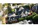 An aerial view of a traditional home with a three-car garage, a pool, and mature trees at 5473 Heyward Square Pl, Marietta, GA 30068