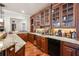 Luxurious basement bar with granite counters, custom wood cabinets, and wine racks for the avid entertainer at 5473 Heyward Square Pl, Marietta, GA 30068