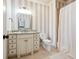 Elegant bathroom with marble countertop, vanity with drawers and a shower with neutral tile at 5473 Heyward Square Pl, Marietta, GA 30068