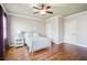 Bright bedroom with hardwood floors, a ceiling fan, and large windows at 5473 Heyward Square Pl, Marietta, GA 30068