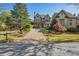 Beautiful home exterior featuring a brick driveway, well-manicured lawn, and lush landscaping at 5473 Heyward Square Pl, Marietta, GA 30068