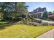 Landscaped front yard and driveway to a lovely home with a three-car garage at 5473 Heyward Square Pl, Marietta, GA 30068