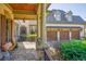 Inviting front porch with stone pillars and an attached three-car garage at 5473 Heyward Square Pl, Marietta, GA 30068
