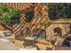Comfortable outdoor seating area with a stone fireplace and stone surround at 5473 Heyward Square Pl, Marietta, GA 30068