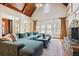 Inviting living room with wood beam ceiling, stone fireplace, and large windows with plantation shutters at 5473 Heyward Square Pl, Marietta, GA 30068