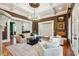 Inviting living room with coffered ceilings, a fireplace, hardwood floors, and french doors at 5473 Heyward Square Pl, Marietta, GA 30068