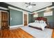 Spacious main bedroom featuring hardwood floors, tray ceilings, and a ceiling fan with light at 5473 Heyward Square Pl, Marietta, GA 30068