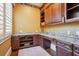 This home office offers custom cabinets, granite countertops, and hardwood floors, and natural light from the window at 5473 Heyward Square Pl, Marietta, GA 30068