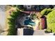 Aerial view of an in-ground pool surrounded by lush landscaping, seating, and a pergola at 5473 Heyward Square Pl, Marietta, GA 30068