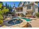 Stunning pool with a waterfall feature, spa, and lush landscaping on a private lot at 5473 Heyward Square Pl, Marietta, GA 30068