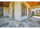 Spacious covered porch featuring stone flooring and pillars with seating at 5473 Heyward Square Pl, Marietta, GA 30068