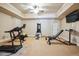 Well-equipped home gym with treadmill, weights, and mirrored wall for a complete fitness experience at 5473 Heyward Square Pl, Marietta, GA 30068