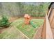 Aerial view of the backyard with a wooden playset and lush green lawn at 603 Redcoat Cir, Canton, GA 30114