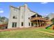 Exterior view of home with spacious backyard and outdoor deck and access to basement at 603 Redcoat Cir, Canton, GA 30114