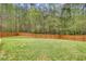 Large, well-maintained backyard surrounded by a wooden fence and mature trees at 603 Redcoat Cir, Canton, GA 30114