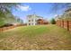 Expansive backyard featuring a wooden fence, lush grass, and a charming playhouse with deck at 603 Redcoat Cir, Canton, GA 30114