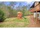 Wide backyard with a wooden playset and green space at 603 Redcoat Cir, Canton, GA 30114