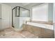 Well-lit bathroom with a soaking tub and a separate shower with glass surround at 603 Redcoat Cir, Canton, GA 30114