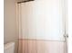Bathroom shows white patterned shower curtain with partial view of toilet at 603 Redcoat Cir, Canton, GA 30114