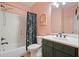 Bathroom with shower-tub combo, floral shower curtain, and a dark green vanity at 603 Redcoat Cir, Canton, GA 30114