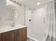 Well-lit bathroom featuring a walk-in shower with glass enclosure and modern fixtures at 603 Redcoat Cir, Canton, GA 30114