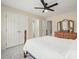 Bedroom with carpet, ceiling fan, a dresser, and two access doors at 603 Redcoat Cir, Canton, GA 30114