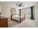 Bright bedroom with a ceiling fan, carpet, and decorative wall art over the bed at 603 Redcoat Cir, Canton, GA 30114