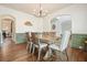 Elegant dining room with green wainscoting and view to the living area at 603 Redcoat Cir, Canton, GA 30114