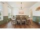 Charming dining room with wainscoting, modern light fixture, and natural light at 603 Redcoat Cir, Canton, GA 30114