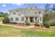 Charming two-story home with a symmetrical facade, dormer windows, a welcoming front porch, and mature landscaping at 603 Redcoat Cir, Canton, GA 30114