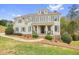 Charming two-story home with a symmetrical facade, dormer windows, a welcoming front porch, and mature landscaping at 603 Redcoat Cir, Canton, GA 30114