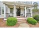 Inviting front porch with seating, detailed trim, and a decorative front door, showcasing the home's curb appeal at 603 Redcoat Cir, Canton, GA 30114